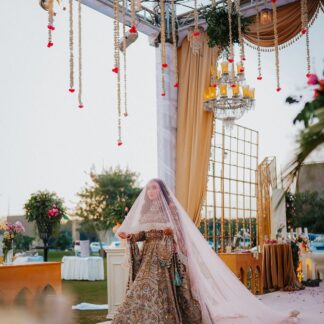 Blush pink Nikkah veil with sheer fabric, embroidered scalloped border and extra-long flowing train for a Pakistani Muslim bride.