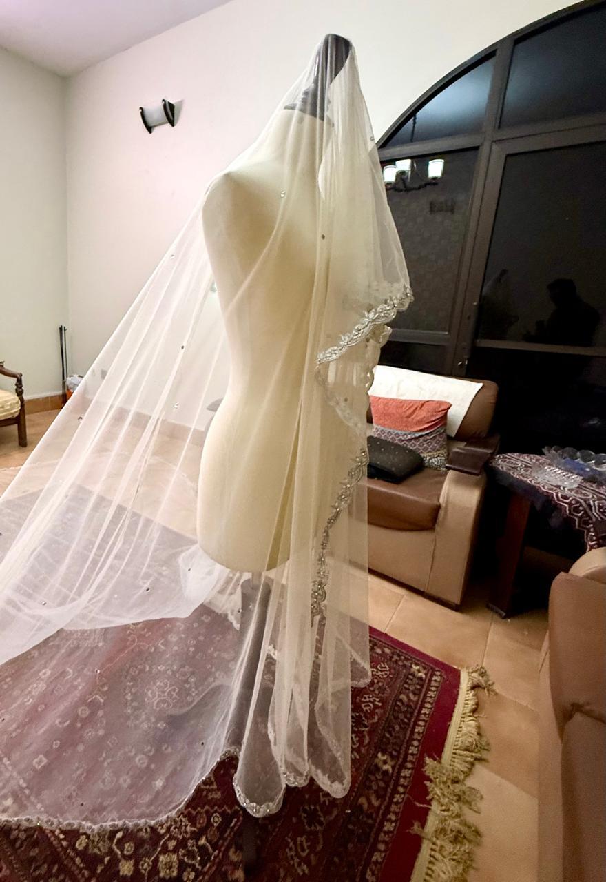 Extra-long ivory bridal veil with delicate sequin embellishments, sheer net fabric and an embroidered lace border for a Nikkah wedding.