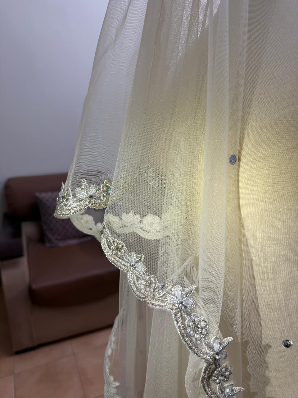 Extra-long ivory bridal veil with delicate sequin embellishments, sheer net fabric and an embroidered lace border for a Nikkah wedding.