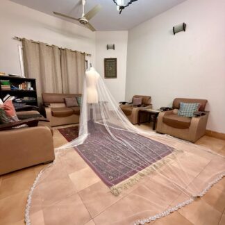Extra-long ivory bridal veil with delicate sequin embellishments, sheer net fabric and an embroidered lace border for a Nikkah wedding.