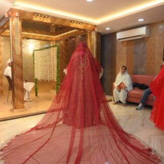 Red Pakistani bridal veil with gold embroidered border, sparkling embellishments, personalized initial detail and extra-long flowing train.