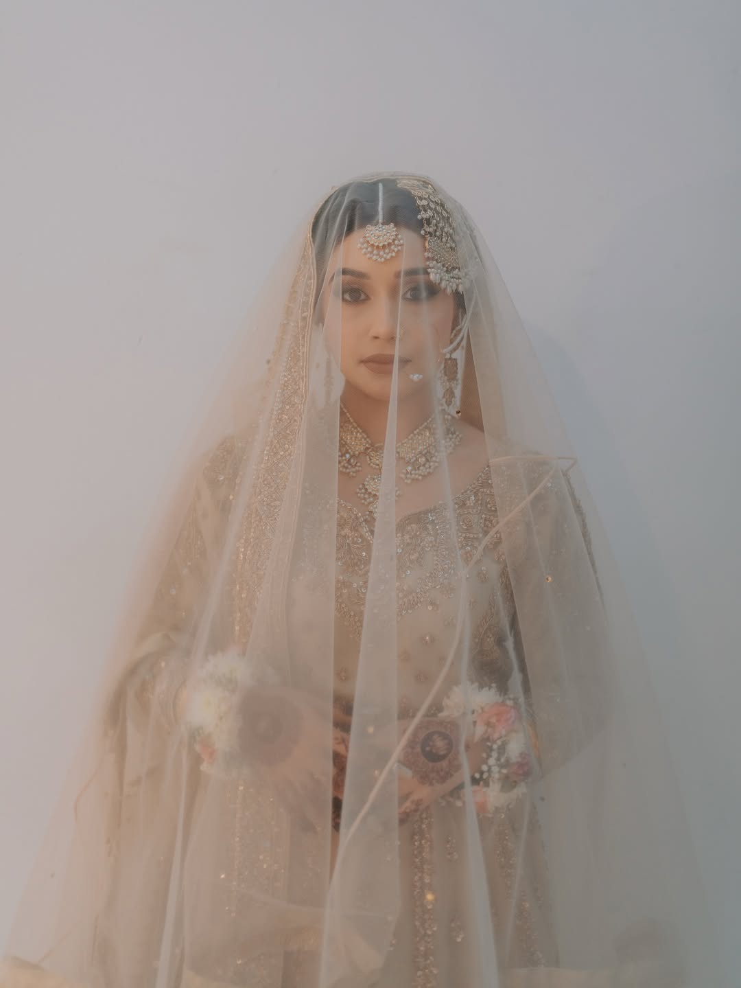 Ivory Nikkah bridal veil with sheer fabric, delicate embellishments and elegant border for a Pakistani Muslim wedding.