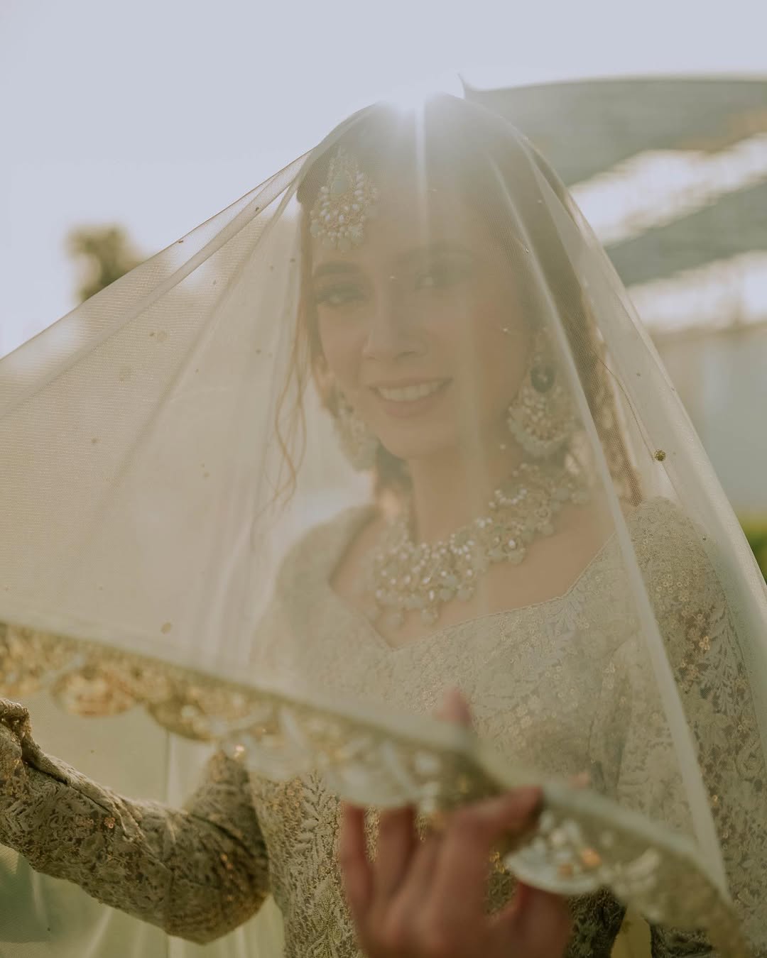 Ivory Nikkah bridal veil with a long sheer design and elegant gold embroidered border for a Pakistani Muslim wedding.