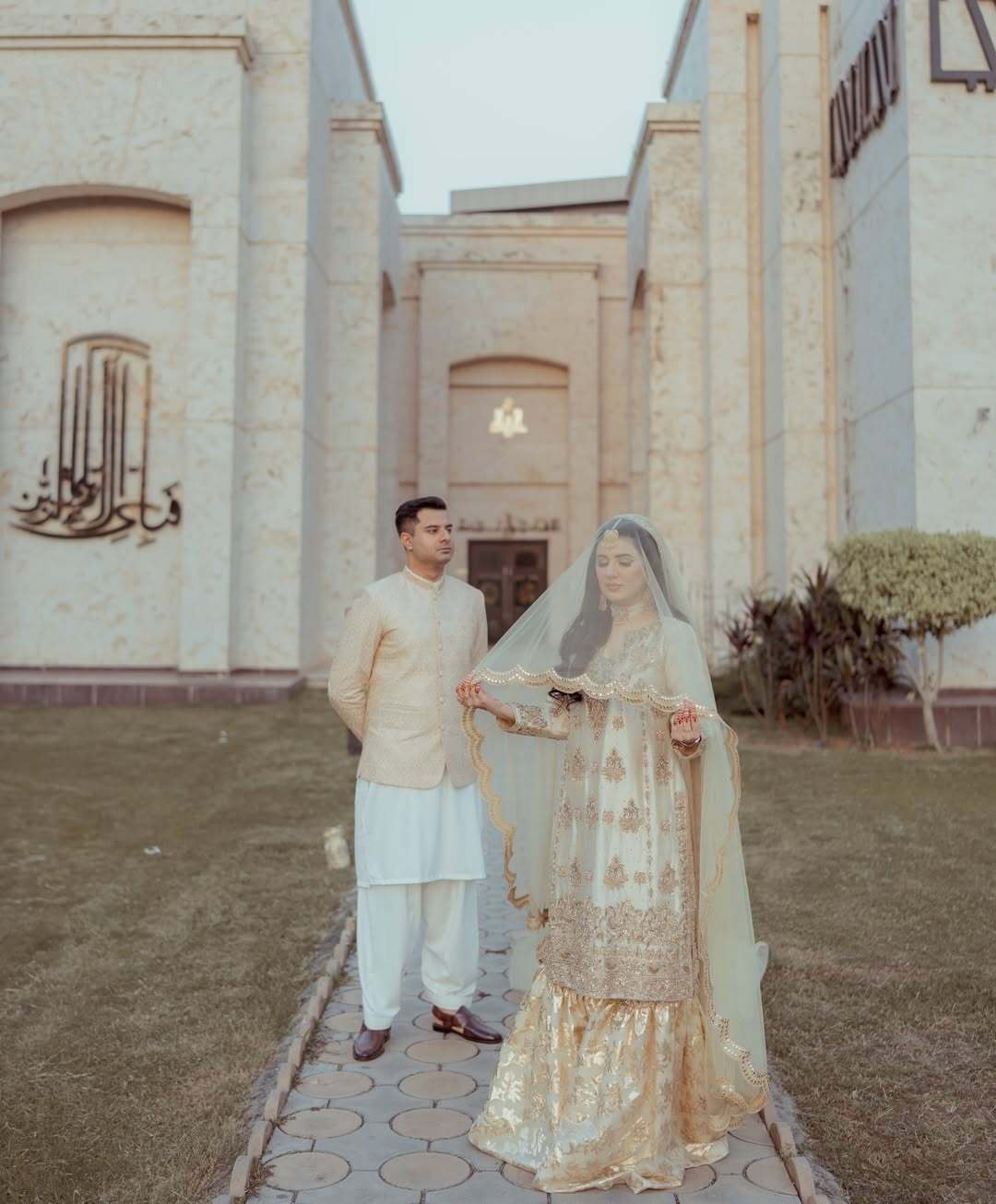 Ivory Pakistani Nikkah dupatta veil with scalloped gold border and reflective detailing styled for a traditional South Asian wedding.