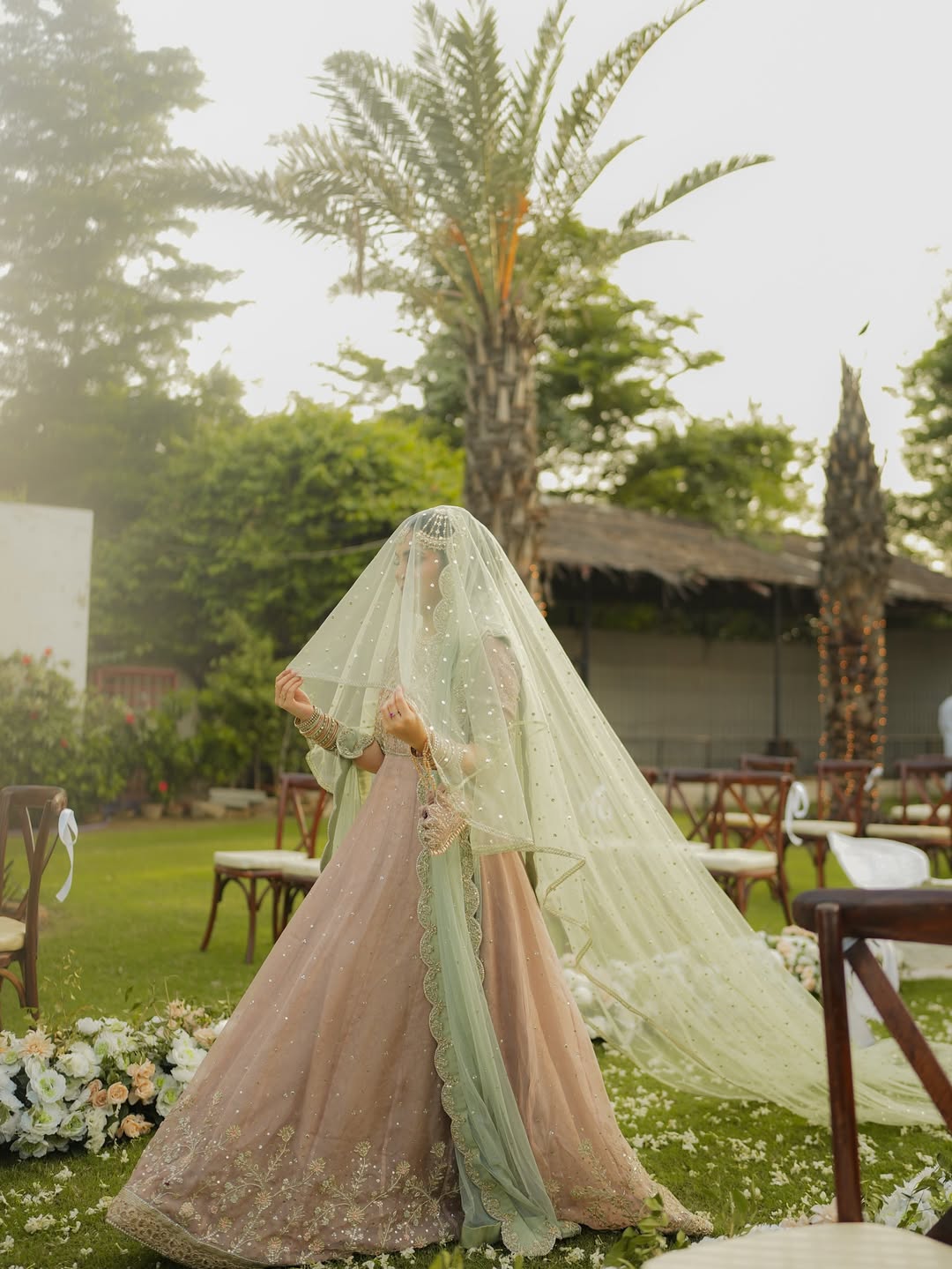 Mint green bridal veil with delicate sequin embellishments, sheer fabric and an extra-long flowing train for a Nikkah wedding.