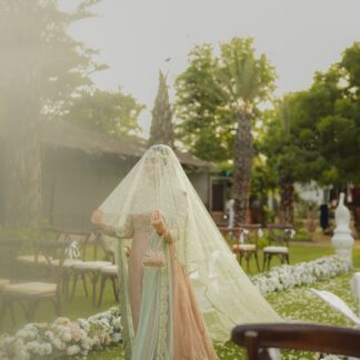 Mint green bridal veil with delicate sequin embellishments, sheer fabric and an extra-long flowing train for a Nikkah wedding.
