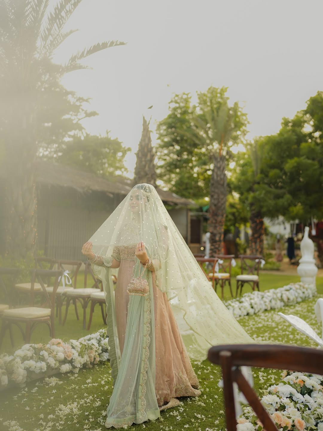 Mint green bridal veil with delicate sequin embellishments, sheer fabric and an extra-long flowing train for a Nikkah wedding.