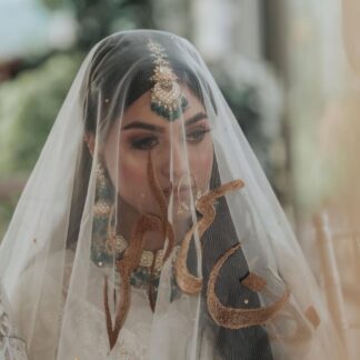 Personalized ivory Nikkah dupatta with custom gold name embroidery and Urdu calligraphy for a Pakistani Muslim bride.