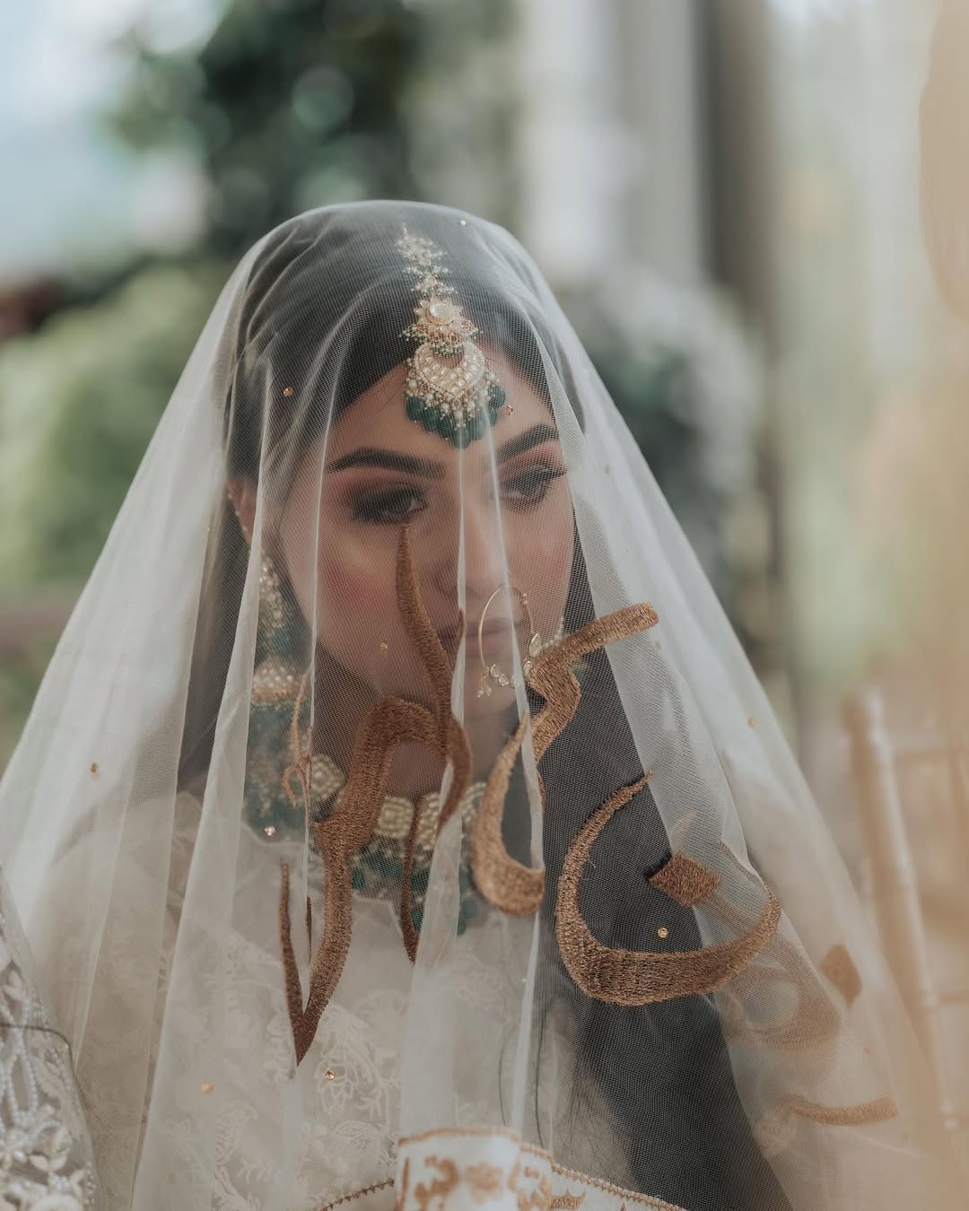 Personalized ivory Nikkah dupatta with custom gold name embroidery and Urdu calligraphy for a Pakistani Muslim bride.