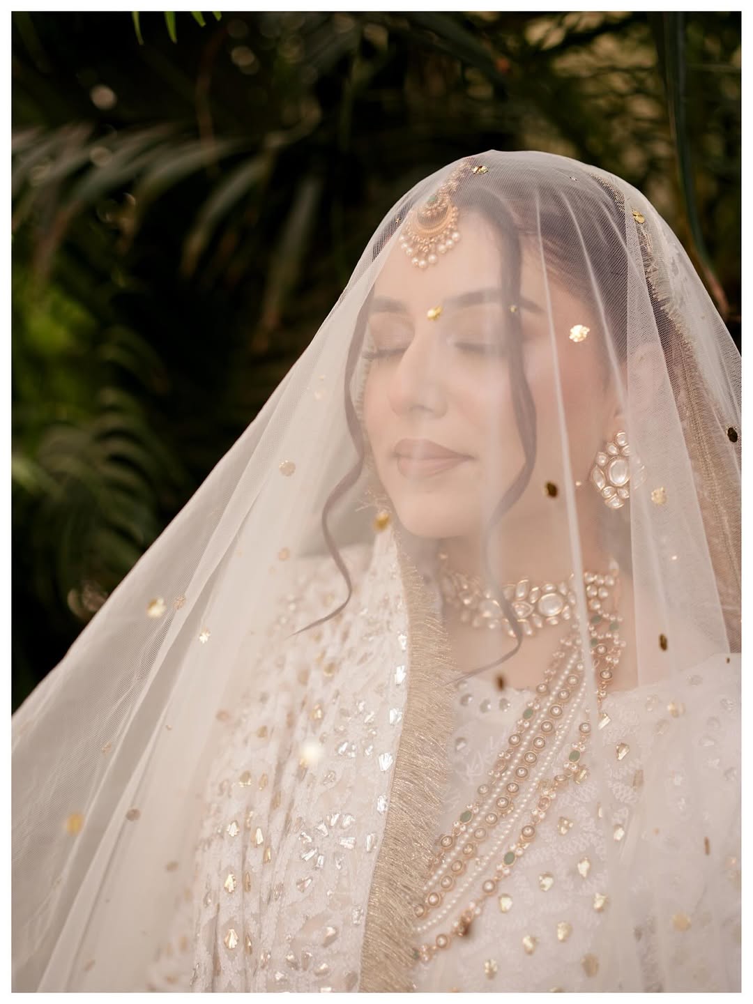 White Nikkah bridal veil with sheer fabric, delicate sequin embellishments and decorative border for a Pakistani Muslim bride.