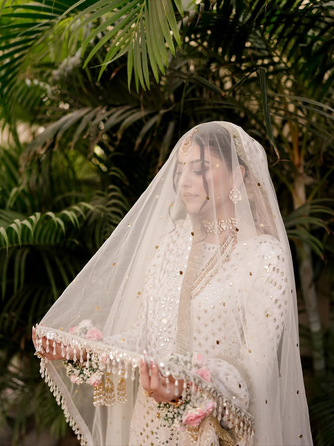 White Nikkah bridal veil with sheer fabric, delicate sequin embellishments and decorative border for a Pakistani Muslim bride.