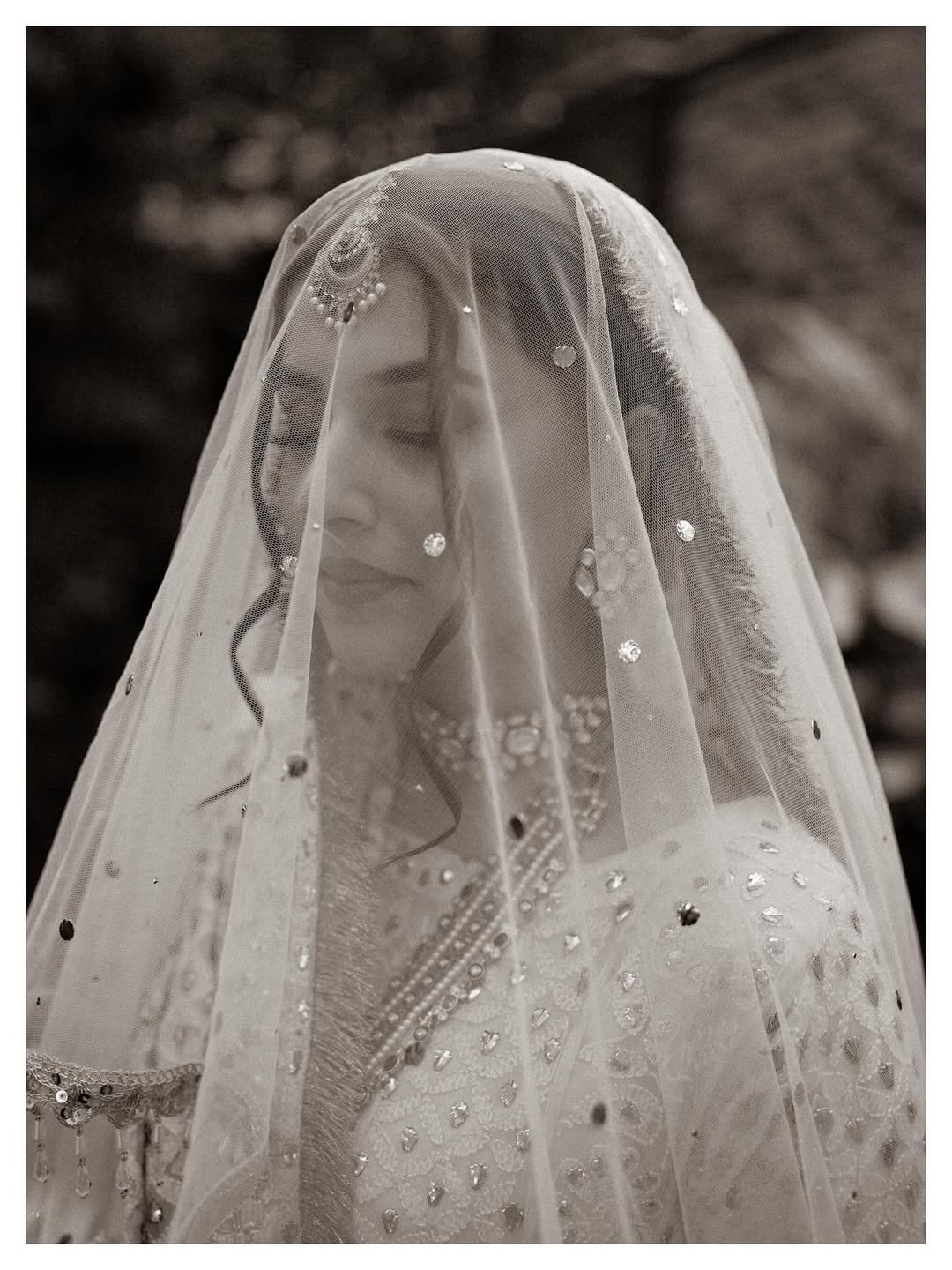 White Nikkah bridal veil with sheer fabric, delicate sequin embellishments and decorative border for a Pakistani Muslim bride.