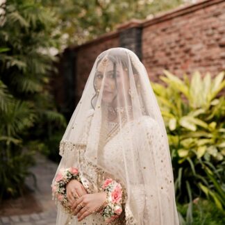 White Nikkah bridal veil with sheer fabric, delicate sequin embellishments and decorative border for a Pakistani Muslim bride.