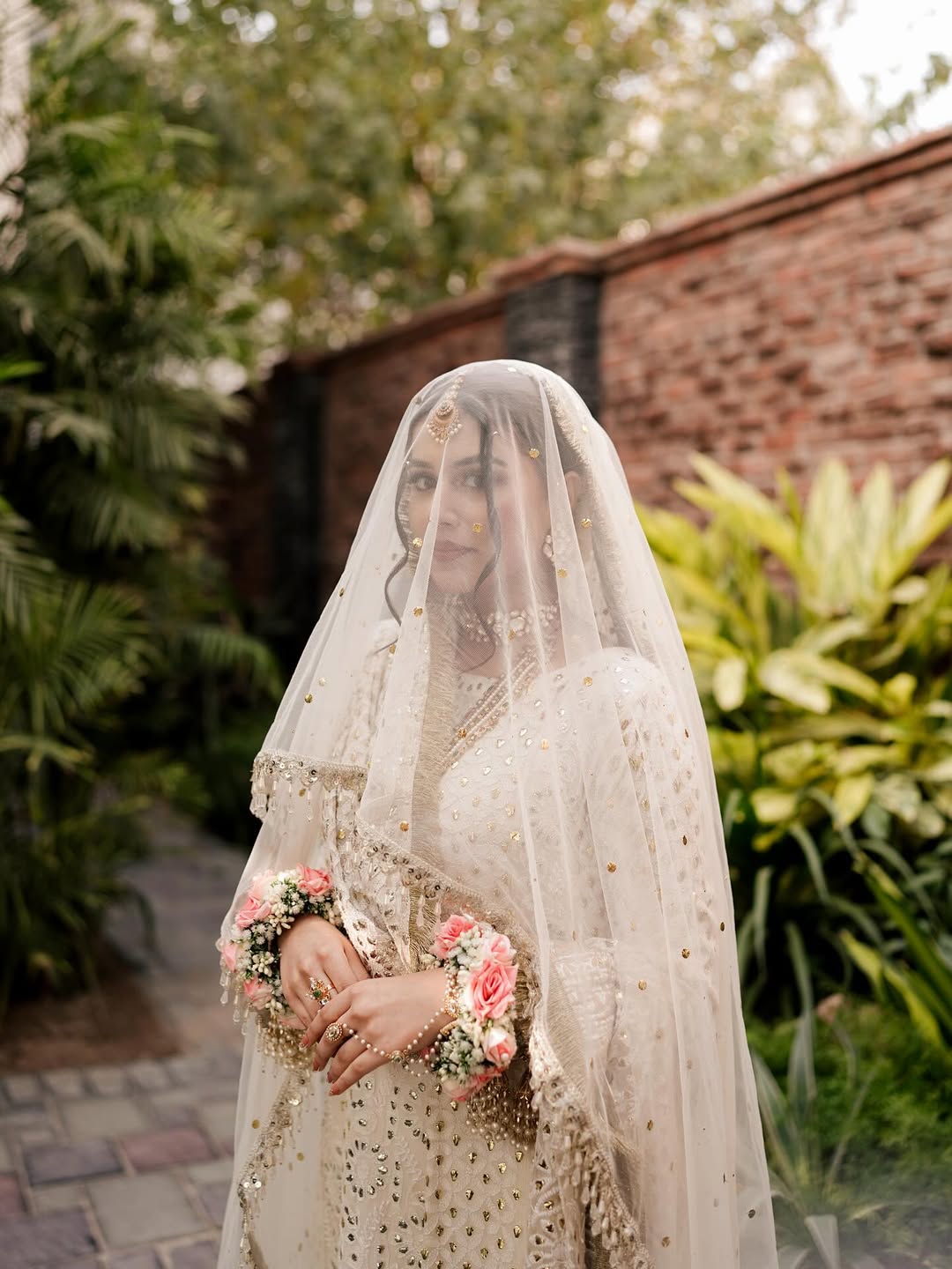 White Nikkah bridal veil with sheer fabric, delicate sequin embellishments and decorative border for a Pakistani Muslim bride.