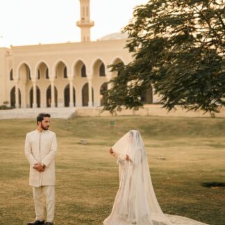 Long Nikkah bridal veil in sheer ivory fabric with delicate embellishments and a flowing train for a Pakistani Muslim wedding.