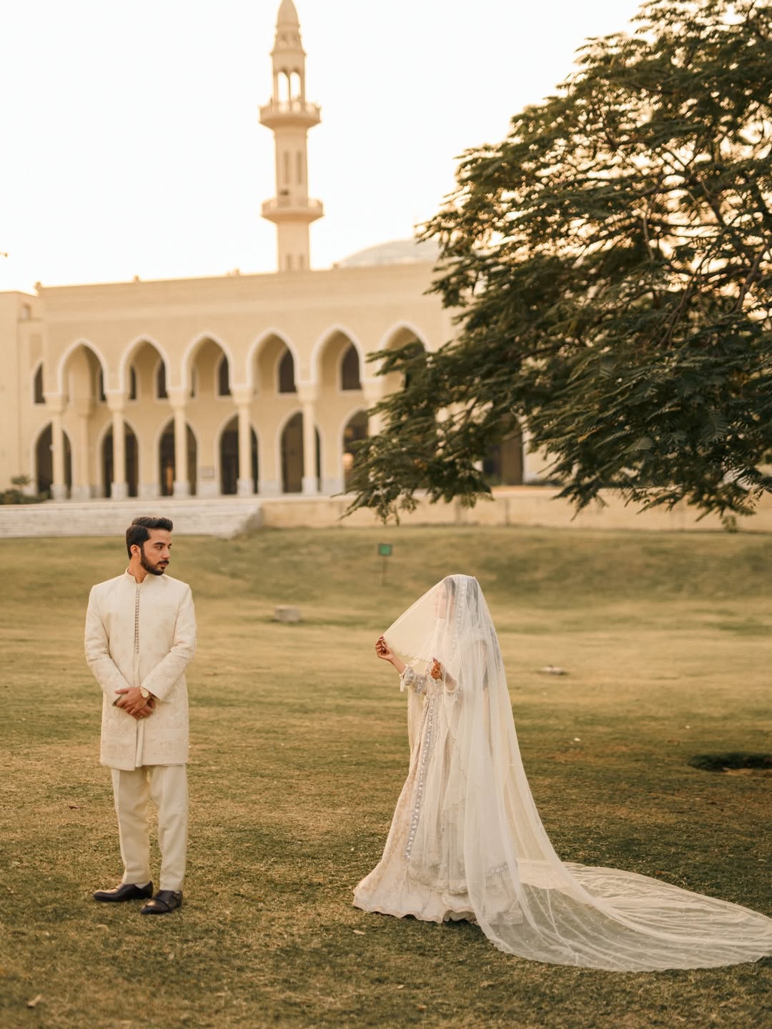 Long Nikkah bridal veil in sheer ivory fabric with delicate embellishments and a flowing train for a Pakistani Muslim wedding.
