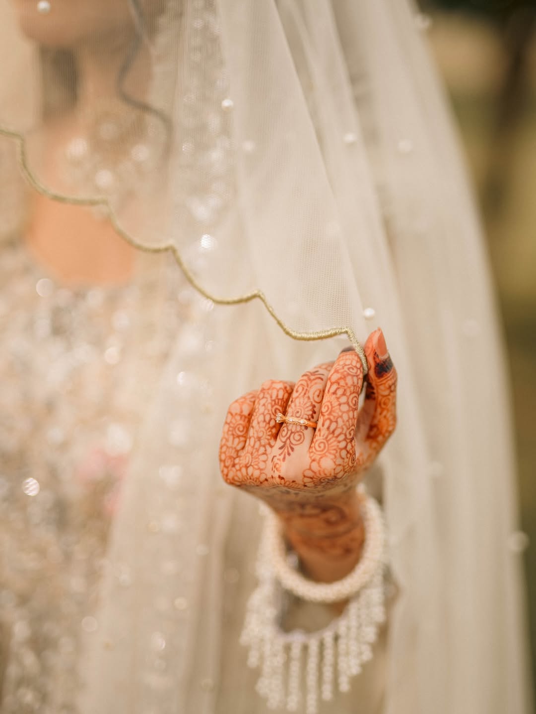 Long Nikkah bridal veil in sheer ivory fabric with delicate embellishments and a flowing train for a Pakistani Muslim wedding.