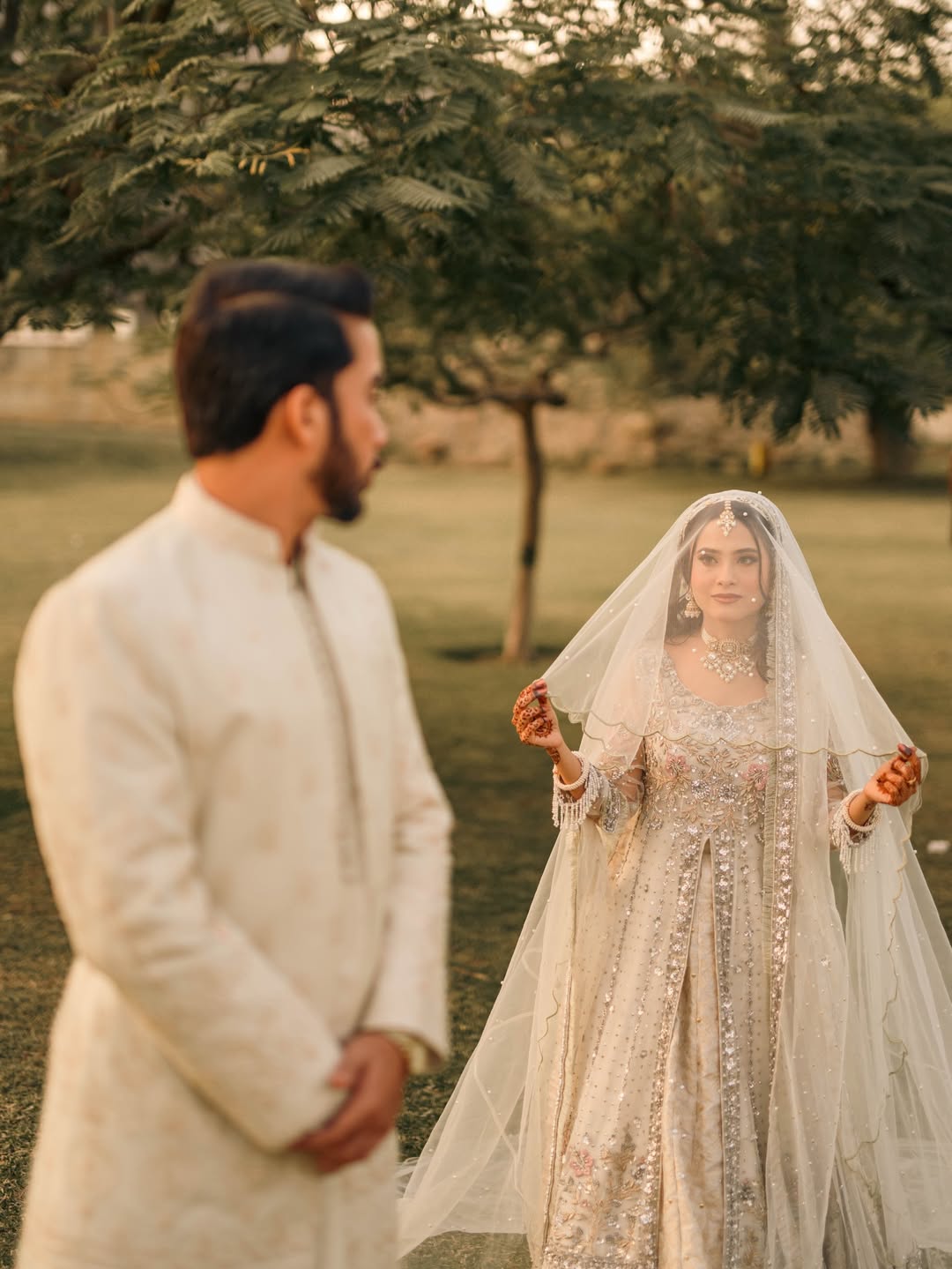 Long Nikkah bridal veil in sheer ivory fabric with delicate embellishments and a flowing train for a Pakistani Muslim wedding.