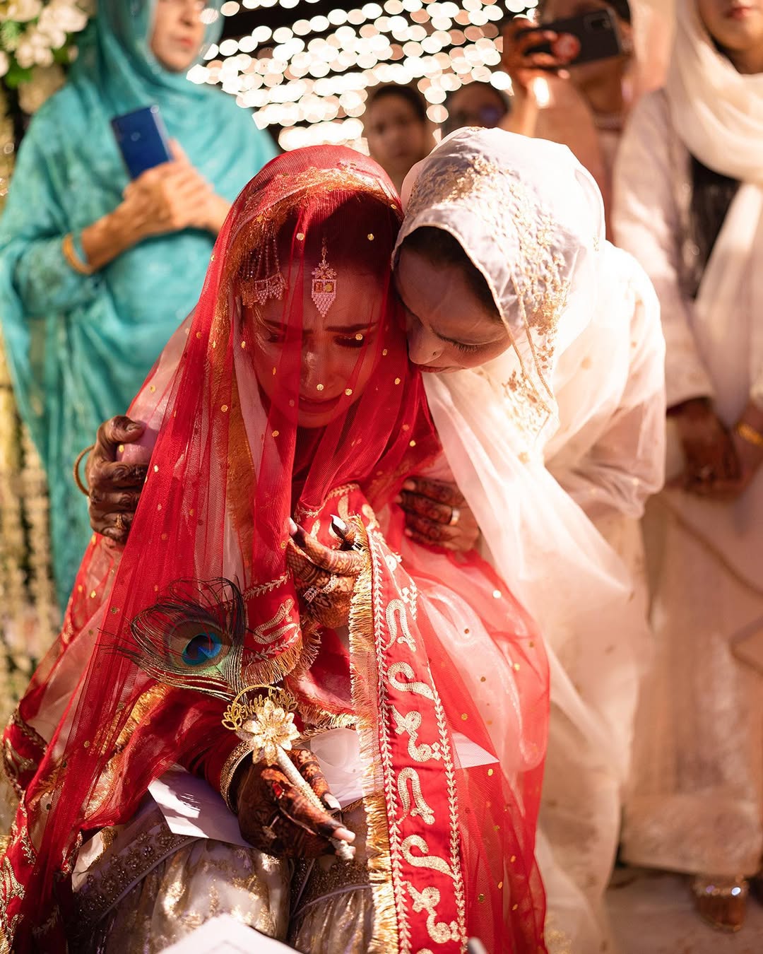 Red Nikkah dupatta with gold embroidery, sheer net fabric and decorative fringe border for a Pakistani Muslim bride.