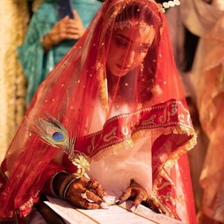 Red Nikkah dupatta with gold embroidery, sheer net fabric and decorative fringe border for a Pakistani Muslim bride.