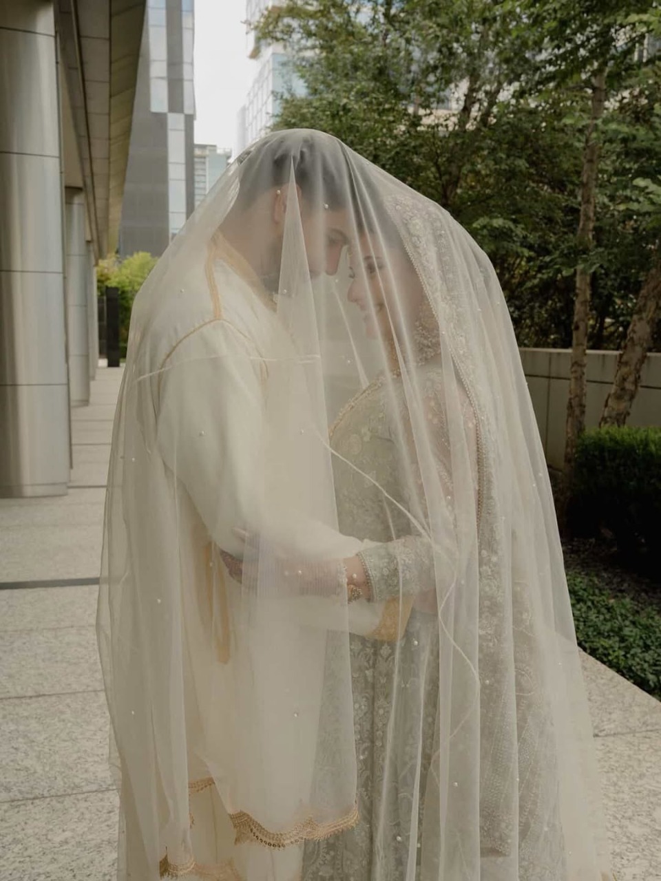 Long White Nikkah Veil with sheer fabric, delicate embellishments and an extra-long flowing train for a Pakistani Muslim bride.