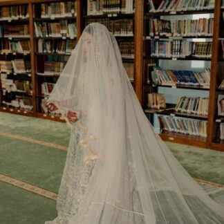 Long White Nikkah Veil with sheer fabric, delicate embellishments and an extra-long flowing train for a Pakistani Muslim bride.
