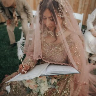 Blush pink bridal veil with sequin embellishments and delicate lace edging for a South Asian wedding bride.