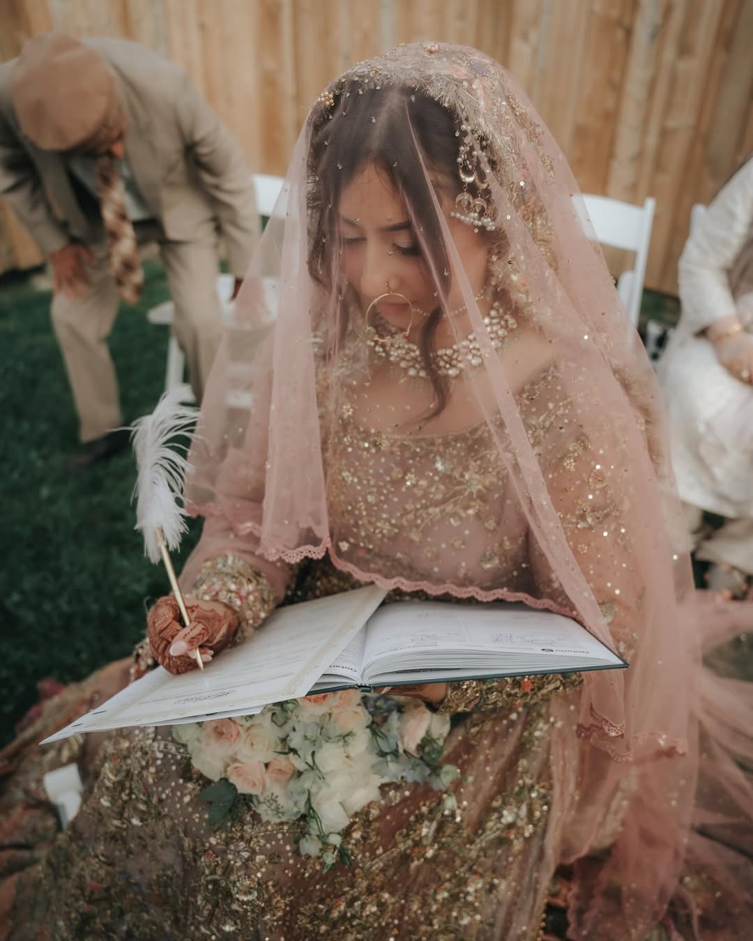 Blush pink bridal veil with sequin embellishments and delicate lace edging for a South Asian wedding bride.