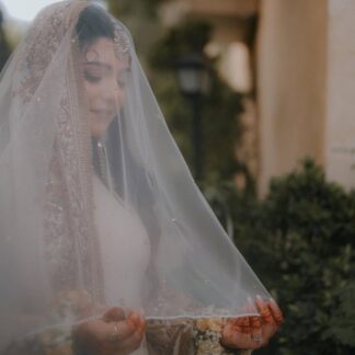 Ivory Pakistani bridal dupatta veil with delicate detailing and elegant border styled for a traditional South Asian Nikkah ceremony