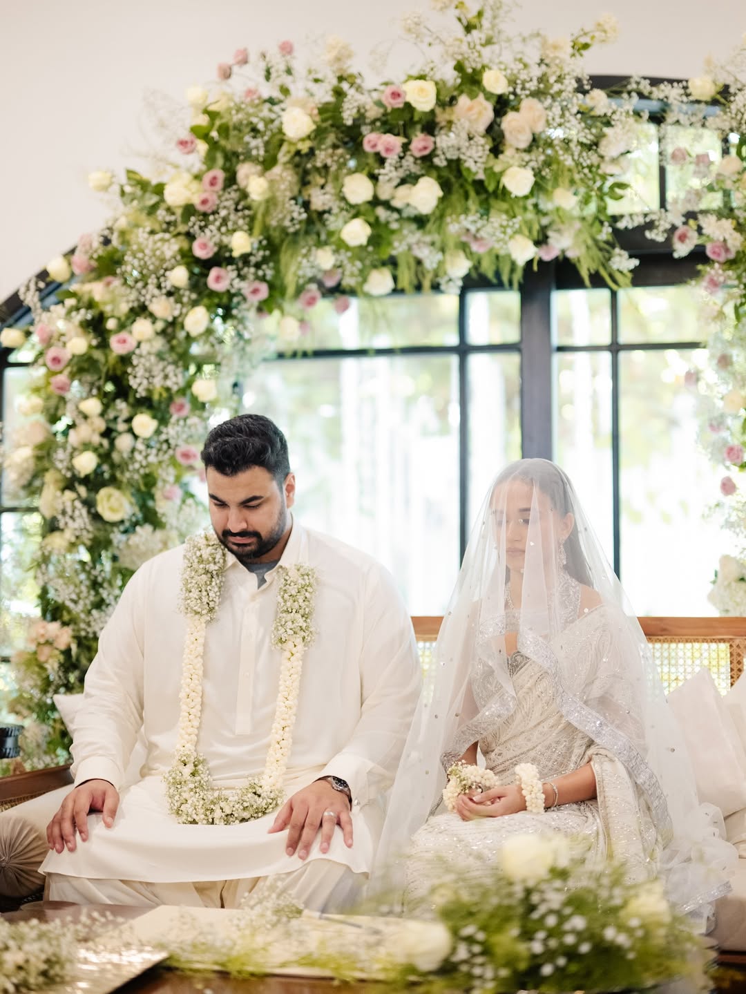 White Pakistani Nikkah dupatta veil with delicate silver detailing and statement border worn by a bride during the Nikkah signing ceremony.