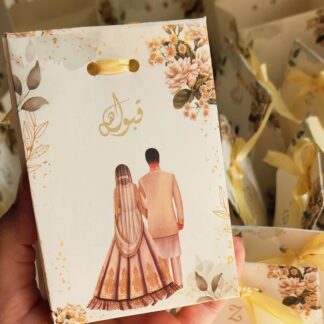 Floral Nikkah favor box with bride and groom illustration, elegant flower details and ribbon for Pakistani and Muslim wedding celebrations.