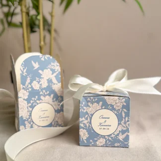 Blue floral cube Nikkah favor box with personalized couple names, wedding date and ivory satin ribbon for Pakistani and Muslim weddings.