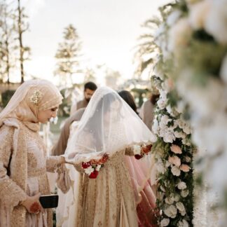 Ivory Nikkah Bridal Veil with sheer embellished fabric and delicate scalloped border worn by a Pakistani Muslim bride during her wedding ceremony.