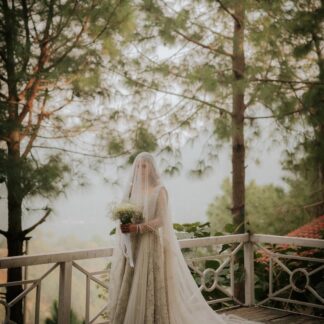 Ivory Nikkah Bridal Veil with an extra-long sheer embellished train worn by a Pakistani Muslim bride with an ivory wedding dress.