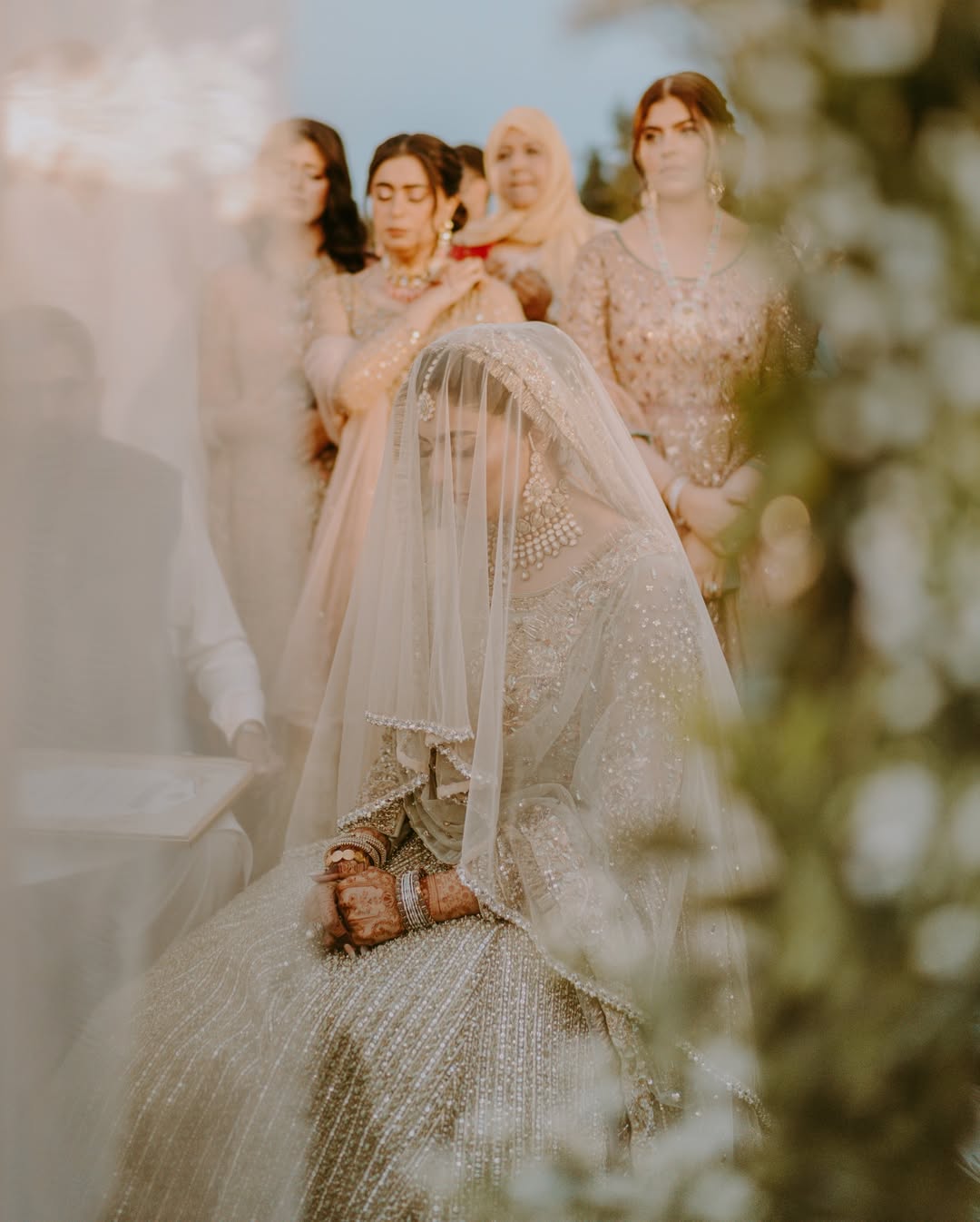 Ivory Nikkah Bridal Veil with sheer flowing fabric and delicate embellished border styled over a traditional Pakistani bridal outfit.
