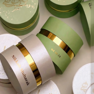 Luxury round Nikkah favor boxes in white and green with gold detailing for Muslim and Pakistani weddings.