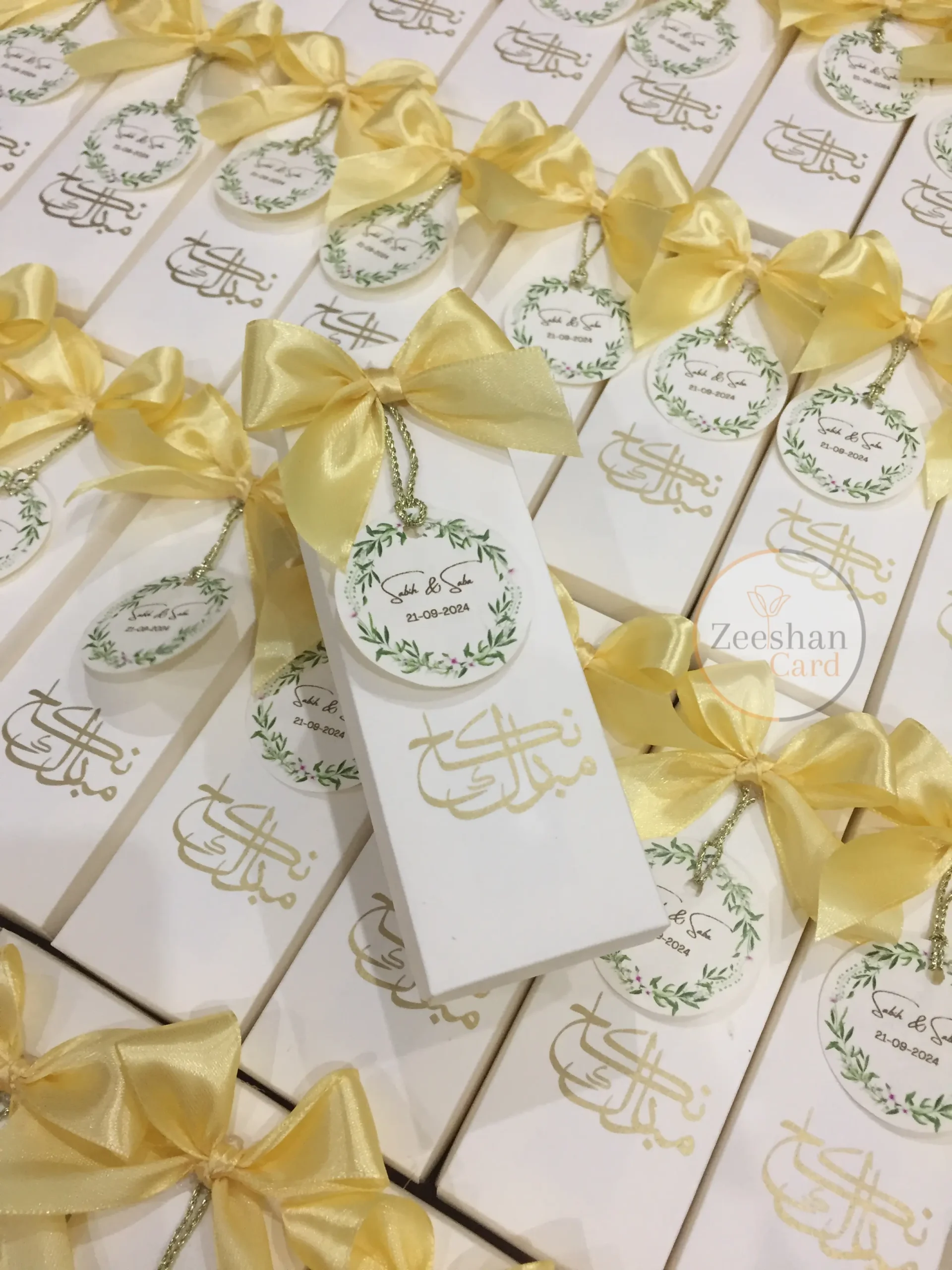 Personalized Nikkah favor boxes with satin bows, custom floral wedding tags and elegant calligraphy for Muslim and Pakistani weddings.