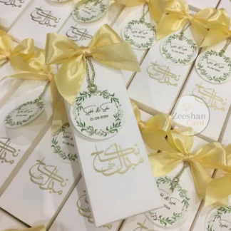 Personalized Nikkah favor boxes with satin bows, custom floral wedding tags and elegant calligraphy for Muslim and Pakistani weddings.