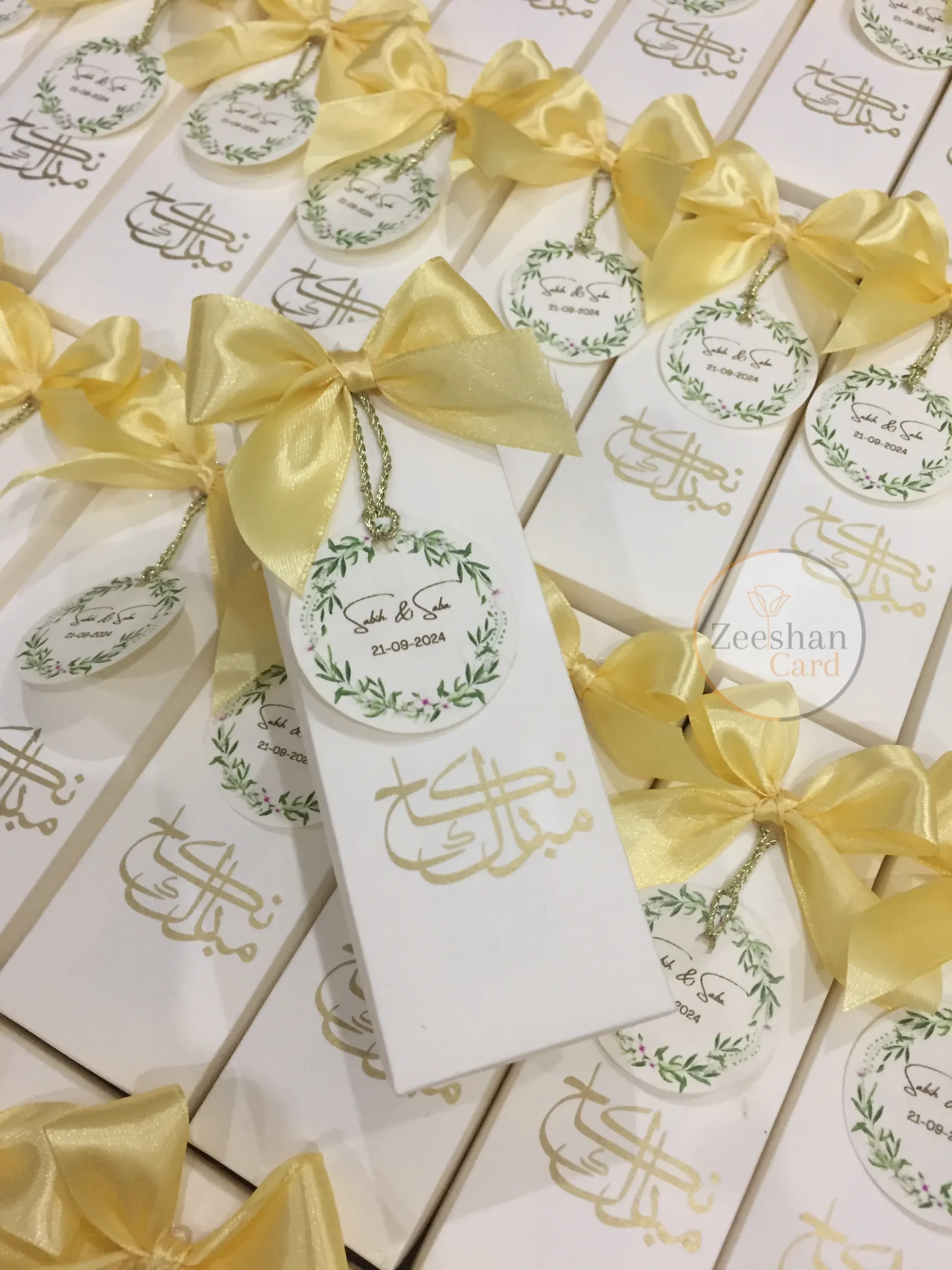 Personalized Nikkah favor boxes with satin bows, custom floral wedding tags and elegant calligraphy for Muslim and Pakistani weddings.