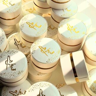 White and gold round Qabool Hai favor boxes for Nikkah, Muslim and Pakistani wedding celebrations.