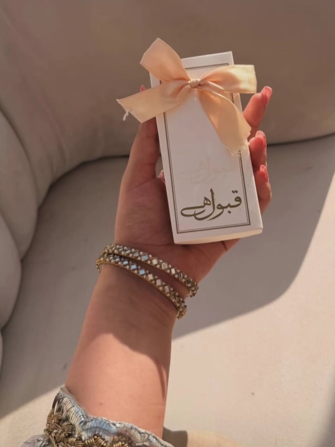 Qabool Hai Nikkah favor box in ivory white with elegant border design and soft ribbon bow for Muslim wedding celebrations.