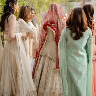 Red Nikkah Bridal Dupatta with sheer embellished fabric and traditional decorative border worn over an ivory Pakistani bridal outfit.