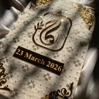 Personalized ivory embroidered Nikkah Nama folder featuring delicate floral embroidery, a metallic gold couple's monogram, custom wedding date plaque, and ornate gold corner embellishments for Pakistani and Muslim wedding ceremonies in the USA.
