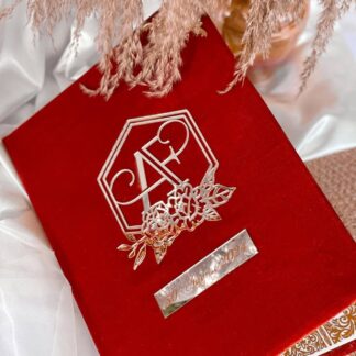 Personalized red velvet Nikkah Nama folder featuring a silver-toned floral monogram with couple's initials and a custom wedding date plaque for Pakistani Muslim wedding ceremonies in the USA.