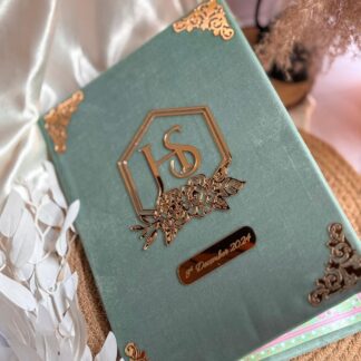 Personalized sage green velvet Nikkah Nama folder featuring a gold floral monogram, decorative gold corner embellishments, and a custom wedding date plaque for Pakistani and Muslim wedding ceremonies in the USA.