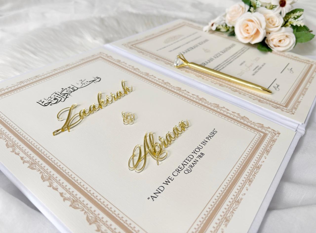 Personalized white Nikkah Nama folder with elegant gold floral monogram, custom couple initials, wedding date plaque, and intricate gold corner embellishments for Pakistani and Muslim wedding ceremonies in the USA.
